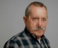 Foto von einem grauhaarigen Mann im Flanellhemd, das Gesicht ist verpixelt