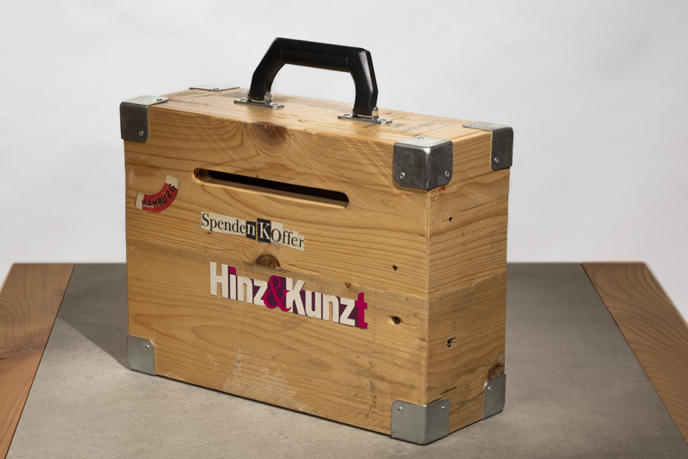 Ein Koffer aus Holz mit Hinz&Kunzt-Logo und Schlitz zum Einwerfen von Spenden