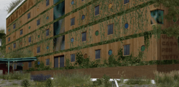 Ein holzvertäfeltes Haus mit viel Grün an der Fassade, darauf die Aufschrift "Una casa per tutti"