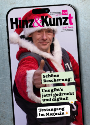 Ein Smartphonebildschirm mit einem Chatverlauf: "Schöne Bescherung! Uns gibt's jetzt gedruckt und digital!" – "Testzugang im Magazin!" Im Hintergrund ein Weihnachtsmann