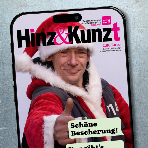 Ein Smartphonebildschirm mit einem Chatverlauf: "Schöne Bescherung! Uns gibt's jetzt gedruckt und digital!" – "Testzugang im Magazin!" Im Hintergrund ein Weihnachtsmann