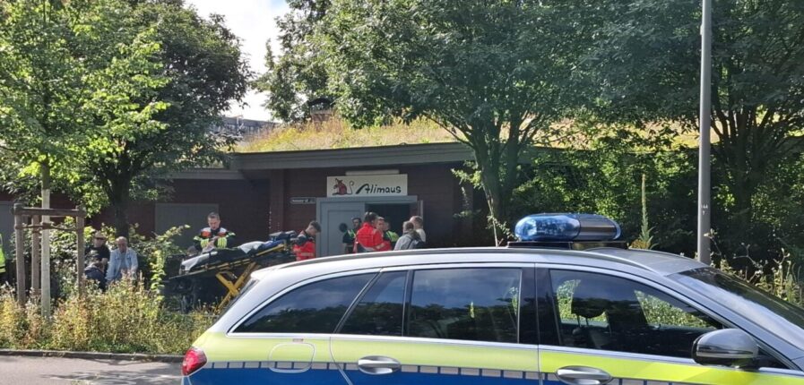Ein Polizeiauto und mehrere Einsatzkräfte vor der Alimaus